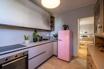 a kitchen with a pink refrigerator in a room at Stylish 2BR with Balcony, Northern Suburbs in Athens