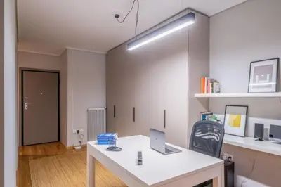 an office with a white desk with a laptop on it at Stylish 2BR with Balcony, Northern Suburbs in Athens