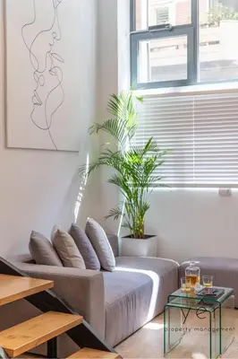 a bed in a room with a window and plants at Seaside Loft Near Piraeus Port at Freatida Beach in Piraeus