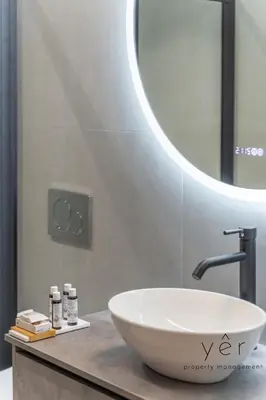 a bathroom with a white sink and a mirror at Seaside Loft Near Piraeus Port at Freatida Beach in Piraeus