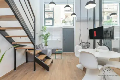 an office with a staircase and a table and chairs at Seaside Loft Near Piraeus Port at Freatida Beach in Piraeus