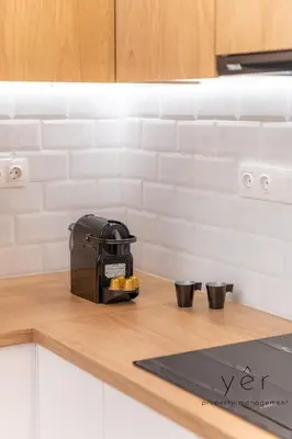 a toaster sitting on top of a kitchen counter at Stylish Loft at Pasalimani 10min to Freatida Beach in Piraeus