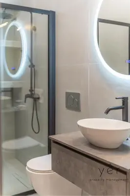 a bathroom with a sink and a toilet and a shower at Stylish Loft at Pasalimani 10min to Freatida Beach in Piraeus