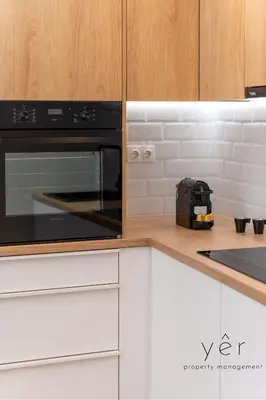 a kitchen with a black microwave oven on a counter at Stylish Loft at Pasalimani 10min to Freatida Beach in Piraeus