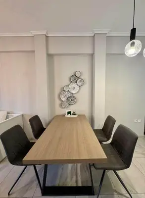 a dining room with a wooden table and chairs at An's Luxury comfort home in Athens