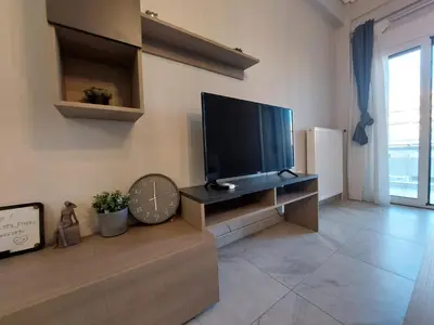 a living room with a large flat screen tv at An's Luxury comfort home in Athens