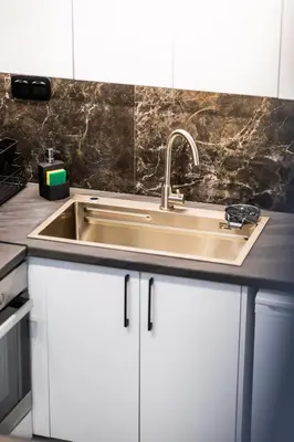 a kitchen with a sink and white cabinets at Studio Noir in Athens