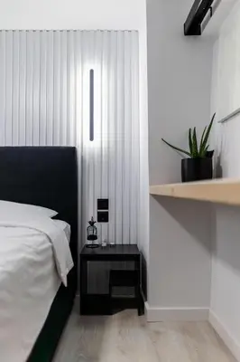 a bedroom with a bed and a side table at Studio Noir in Athens