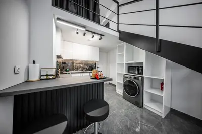 a kitchen with a counter and a washing machine at Studio Noir in Athens