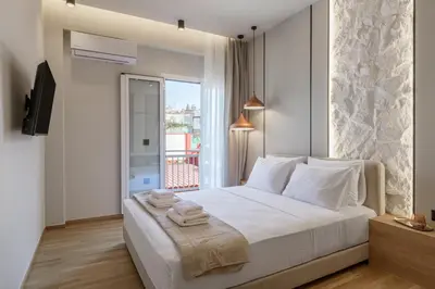 a bedroom with a white bed with towels on it at Thissio Acropolis Retreat in Athens