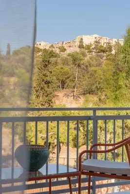 a balcony with a table and a vase at Thissio Acropolis Retreat in Athens