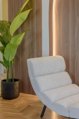 a white chair sitting next to a potted plant at Thissio Acropolis Retreat in Athens