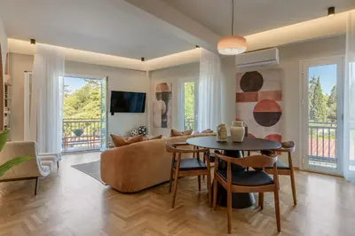 a living room with a couch and a table at Thissio Acropolis Retreat in Athens