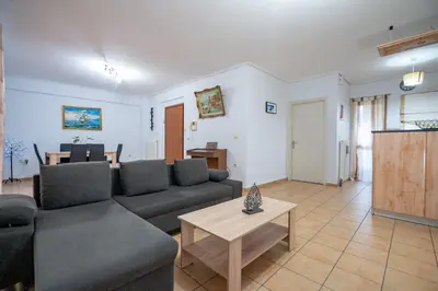 a living room with a couch and a table at Roussas place-Dafni Metro 1 in Athens