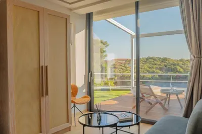 a living room with a view of a balcony at Athens Riviera Suite in Athens