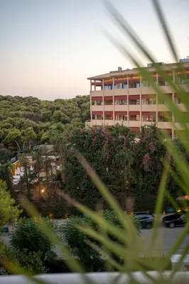 a large building in the middle of a parking lot at Athens Riviera Suite in Athens
