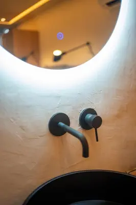 a mirror on a wall with headphones on it at Athens Riviera Suite in Athens