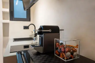 a kitchen counter with a juicer and a bowl of vegetables at Athens Riviera Suite in Athens