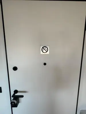 a door with a clock on the side of it at Escape Suites - Sea View in Porto Rafti