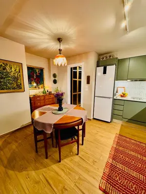 a kitchen with a table and a refrigerator at 70's Vintage Hideaway Appartment in Athens