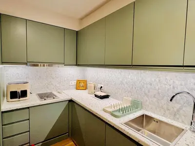 a kitchen with green cabinets and a sink at 70's Vintage Hideaway Appartment in Athens
