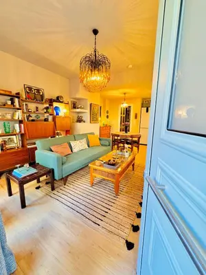 a living room with a couch and a table at 70's Vintage Hideaway Appartment in Athens