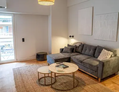 a living room with a couch and a table at Philosykos Suite in Athens