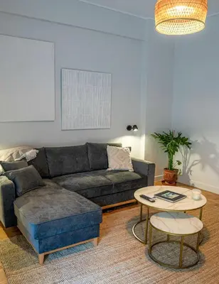 a living room with a couch and a table at Philosykos Suite in Athens