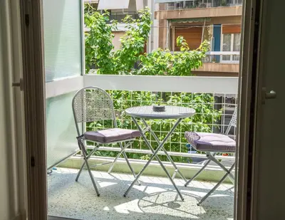 a table and two chairs on a balcony at Philosykos Suite in Athens