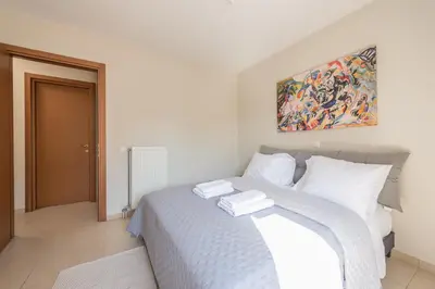 a bedroom with a bed with two towels on it at Cozy 2 bedroom flat near Gazi in Athens
