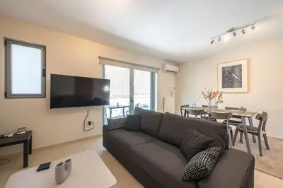a living room with a couch and a table at Cozy 2 bedroom flat near Gazi in Athens