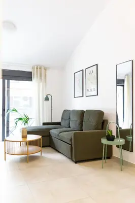 a living room with a couch and a table at Noon Smart Residences in Athens
