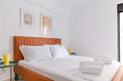 a bedroom with a large white bed with white pillows at Noon Smart Residences in Athens
