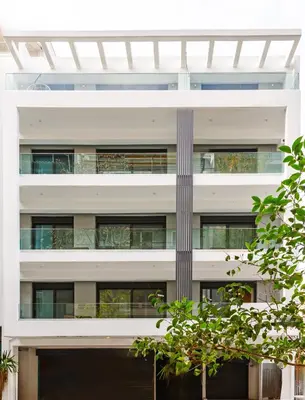 an external view of a white building with windows at Noon Smart Residences in Athens
