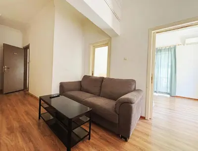 a living room with a couch and a table at 2 bedroom near Dafni metro in Athens