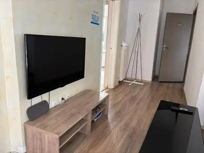 a living room with a flat screen tv on a wall at 2 bedroom near Dafni metro in Athens