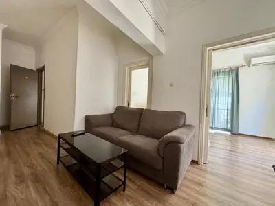 a living room with a couch and a coffee table at 2 bedroom near Dafni metro in Athens