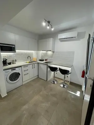 a white kitchen with a sink and a dishwasher at Central Studio next to Metro in Piraeus