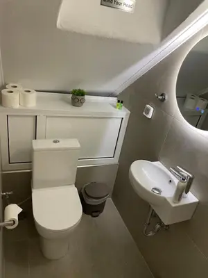 a bathroom with a white toilet and a sink at Central Studio next to Metro in Piraeus