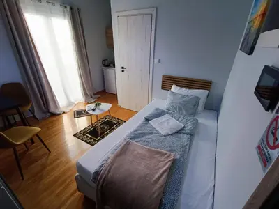 a small bedroom with a bed and a window at Kresorts 13 in Athens