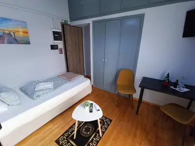 a bedroom with a bed and a table and a desk at Kresorts 13 in Athens