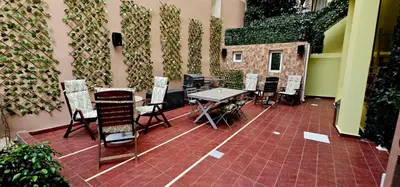 a patio with a table and chairs next to a wall at Kresorts 13 in Athens