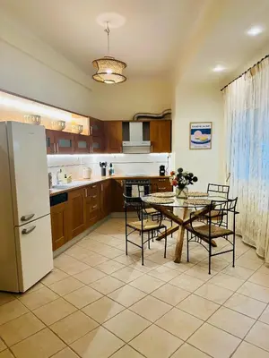a kitchen with a table and chairs and a refrigerator at Sem Athens House -entire 70m2 house- in Athens
