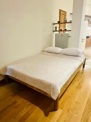 a bed with two pillows on it in a room at Sem Athens House -entire 70m2 house- in Athens