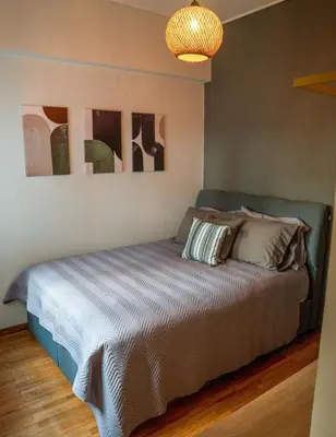 a bedroom with a bed with two pillows on it at The Fig Tree Flat in Athens