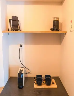 a room with four black pots on a shelf at The Fig Tree Flat in Athens