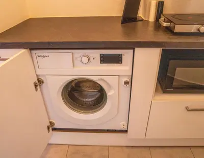 a washing machine in a kitchen with a counter at The Fig Tree Flat in Athens