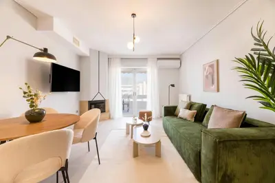 a living room with a green couch and a table at Lightstone 3BR Living in Glyfada by UPSTREET in Athens