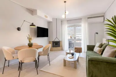 a living room with a green couch and a table at Lightstone 3BR Living in Glyfada by UPSTREET in Athens