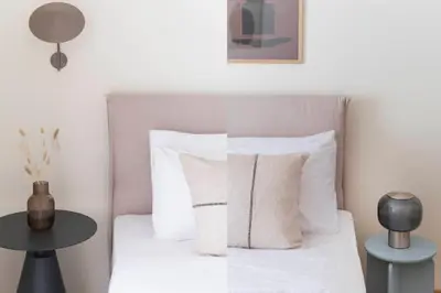 a bedroom with a bed with white sheets and pillows at Lightstone 3BR Living in Glyfada by UPSTREET in Athens